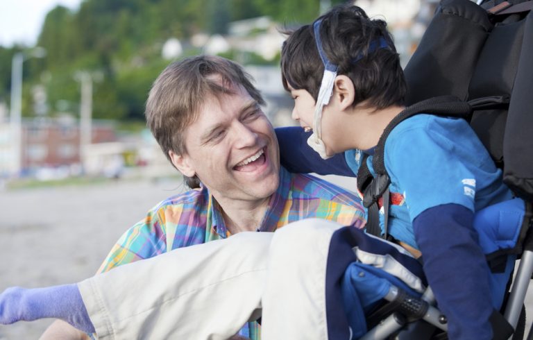 Father,And,Disabled,Five,Year,Old,Son,Laughing,Together,On