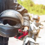 Man in a Motorcycle with helmet and gloves is an important prote