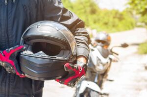 Man in a Motorcycle with helmet and gloves is an important prote